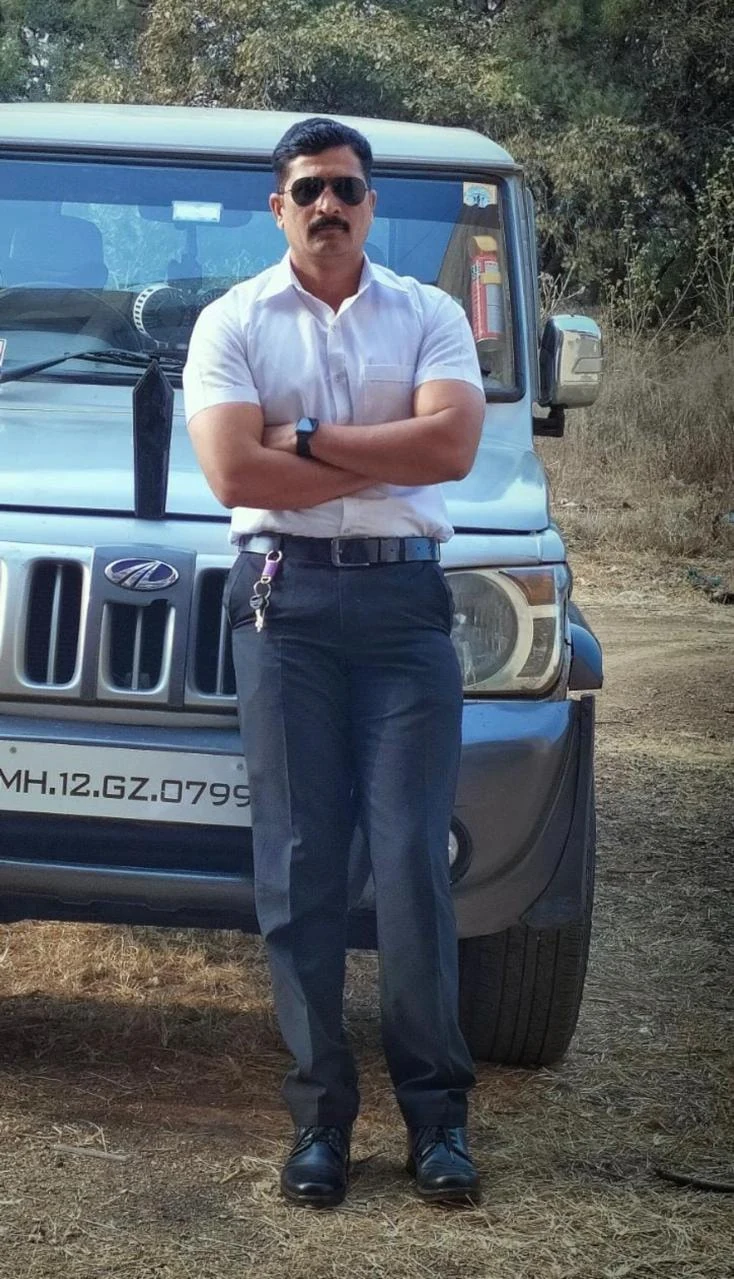 Supplied personal security officer photograph beside a vehicle